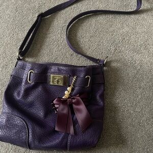 Dark purple crossover purse with bow charm